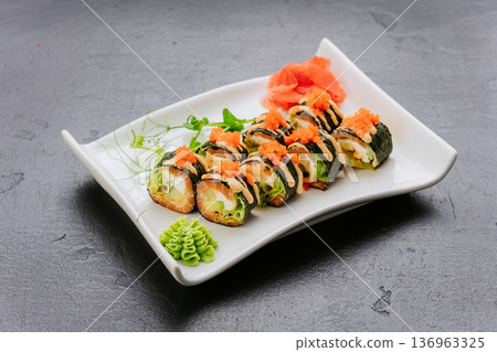 Sushi rolls with avocado seafood and tobiko served on white plate Japanese cuisine 136963325