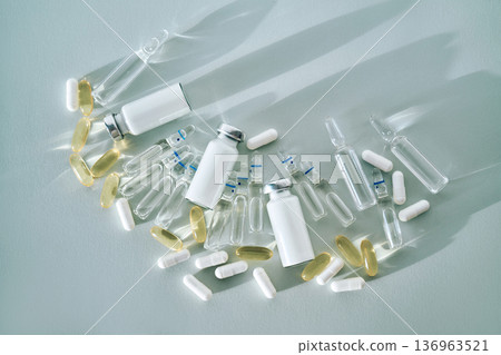 Medicine ampoules vials capsules on light blue background Medicine ampoules vials capsules on light blue background 136963521