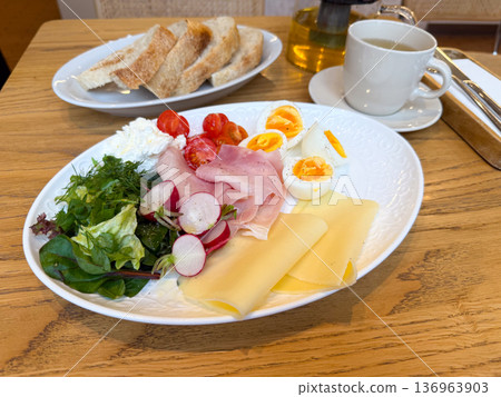 Continental breakfast plate with egg, ham and cheese. Morning nutrition, cafe brunch and balanced healthy meal. Continental breakfast plate with egg, ham and cheese. Morning nutrition, cafe brunch and balanced healthy meal. 136963903