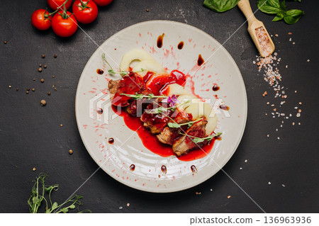 Gourmet roasted meat with berry sauce and pear slices fine dining restaurant plating Gourmet roasted meat with berry sauce and pear slices fine dining restaurant plating 136963936