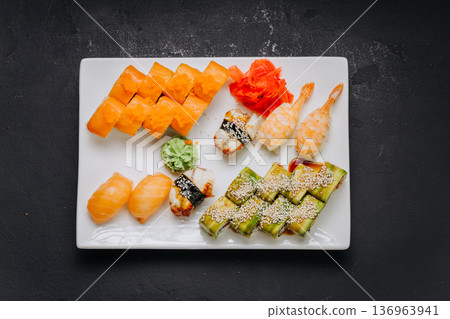 Assorted sushi set with rolls nigiri shrimp and soy sauce on restaurant plate Assorted sushi set with rolls nigiri shrimp and soy sauce on restaurant plate 136963941