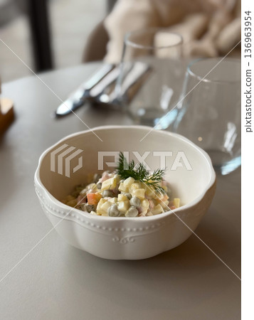 Creamy vegetable salad served in white bowl. Traditional cuisine, festive table and comfort food concept. Creamy vegetable salad served in white bowl. Traditional cuisine, festive table and comfort food concept. 136963954