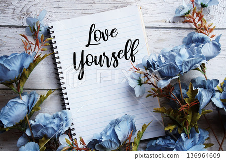 Love Yourself text message with flowers decoration on wooden background Love Yourself text message with flowers decoration on wooden background 136964609