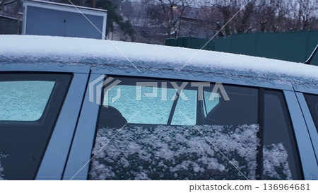 Car covered in fresh snow parked on a street during winter morning. Car covered in fresh snow on a winter morning, ready for the day's commute. Car covered in fresh snow parked on a street during winter morning. Car covered in fresh snow on a winter morning, ready for the day's commute. 136964681