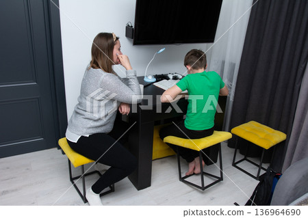Focused learning session between a student and a mentor in a cozy modern room with a minimalistic aesthetic late in the afternoon Focused learning session between a student and a mentor in a cozy modern room with a minimalistic aesthetic late in the afternoon 136964690