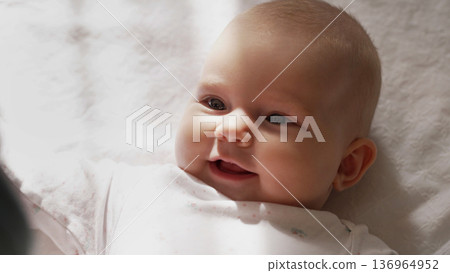 Newborn Baby Girl Lying On White Blanket. Daughter Smiling, Cute Infant Child 136964952