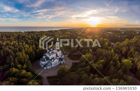 Aerial panoramic top view to Church of the Kazan Icon of Mother of God. Theotokos Cathedral main attraction of city. Rising above green forest. Zelenogorsk, Terijoki, Russia, St. Petersburg. Europe. 136965030