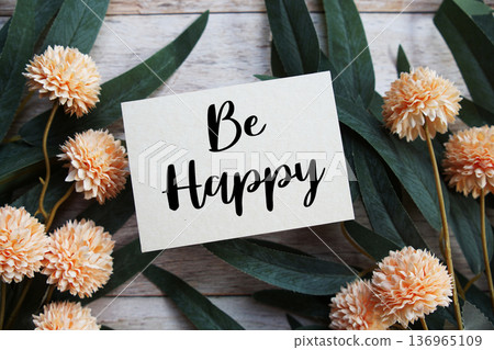 Be Happy Motivational and Inspirational quotes with flowers bouquet decoration on wooen background Be Happy Motivational and Inspirational quotes with flowers bouquet decoration on wooen background 136965109