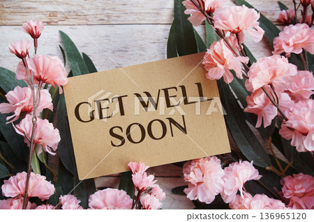 Get Well Soon text with flowers bouquet decoration on wooen background 136965120