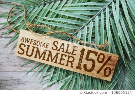 Awesome Summer Sale 15% off with green leaf on wooden background Awesome Summer Sale 15% off with green leaf on wooden background 136965134