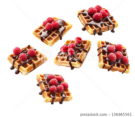 Belgian waffles with raspberries and chocolate isolated on white background as concept of tasty dessert Belgian waffles with raspberries and chocolate isolated on white background as concept of tasty dessert 136965561