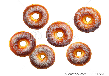 Multiple golden brown glazed donuts with powdered sugar isolated on white background. Concept of sweet treats 136965619