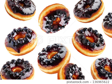 Multiple blueberry glazed donuts with shiny icing and berries scattered in a seamless pattern on white background 136965622