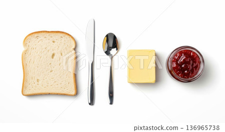 Sliced bread, butter, jam, knife, and spoon arranged on a white background for a breakfast or snack preparation scene 136965738