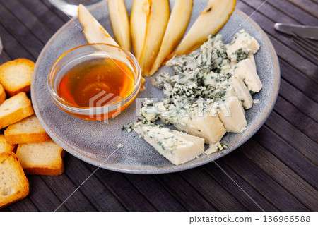 Pieces of blue cheese served on wooden table Pieces of blue cheese served on wooden table 136966588