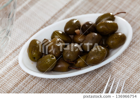 Pickled green olives in bowl on table Pickled green olives in bowl on table 136966754