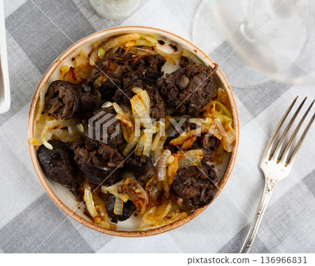 Catalan blood sausage morcilla garnished with baked onions Catalan blood sausage morcilla garnished with baked onions 136966831