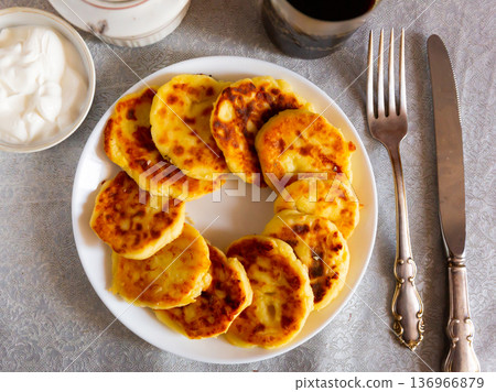Russian syrniki, cheese pancakes with sour cream Russian syrniki, cheese pancakes with sour cream 136966879