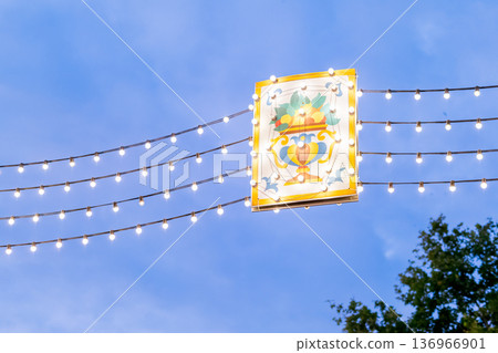 Decorative festive lights with traditional vase illustration against blue twilight sky Decorative festive lights with traditional vase illustration against blue twilight sky 136966901