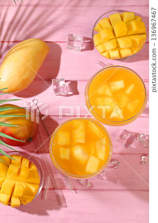 Frozen lemonade or juice with mango slices, mojito with tequila, lemon, and ice, bar and party concept, restaurant and cafe advertising card, restaurant menu, house party advertising banner. 136967467