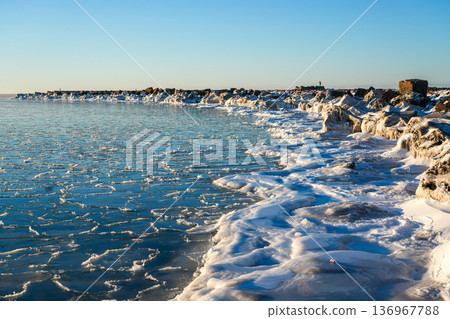 Winter Baltic Sea at Liepaja Harbor Gate Breakwater with Frozen Shoreline, Latvia Coast Winter Baltic Sea at Liepaja Harbor Gate Breakwater with Frozen Shoreline, Latvia Coast 136967788