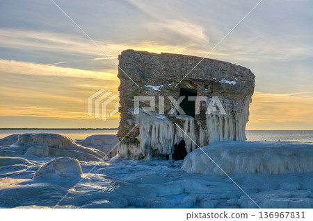 Winter Seascape with Icy Fortification Ruins and thick ice formations on Baltic Sea Coast in Liepaja Winter Seascape with Icy Fortification Ruins and thick ice formations on Baltic Sea Coast in Liepaja 136967831