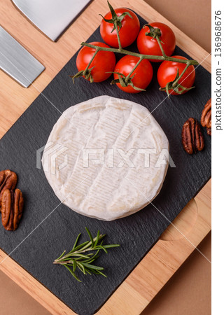 White French cream cheese Brie or Camembert for breakfast. Brie or Camembert cheese 136968676