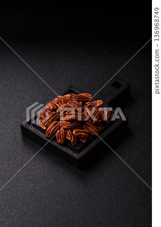 Peeled and roasted pecan nut as an ingredient for healthy food. Pecan nut as a food background Peeled and roasted pecan nut as an ingredient for healthy food. Pecan nut as a food background 136968749
