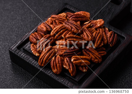 Peeled and roasted pecan nut as an ingredient for healthy food. Pecan nut as a food background 136968750
