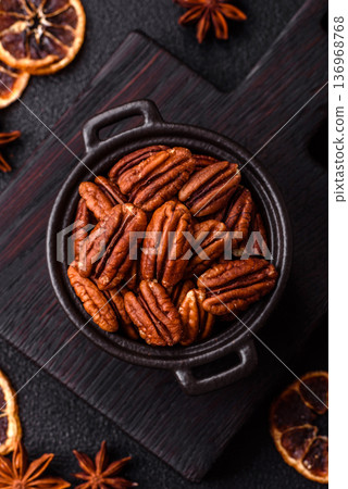 Peeled and roasted pecan nut as an ingredient for healthy food. Pecan nut as a food background Peeled and roasted pecan nut as an ingredient for healthy food. Pecan nut as a food background 136968768