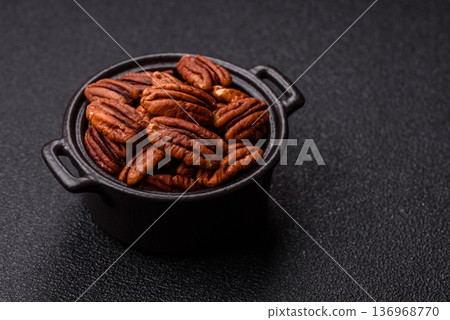 Peeled and roasted pecan nut as an ingredient for healthy food. Pecan nut as a food background Peeled and roasted pecan nut as an ingredient for healthy food. Pecan nut as a food background 136968770