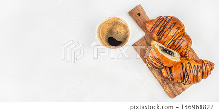 Chocolate croissants with coffee on wooden board isolated on white background 136968822