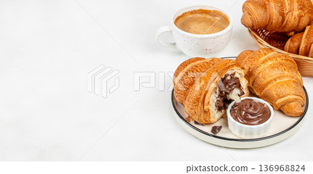 Chocolate croissants with coffee and cocoa spread on white background Chocolate croissants with coffee and cocoa spread on white background 136968824