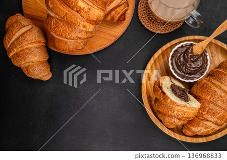 Chocolate croissants with coffee and copy space on dark background 136968833