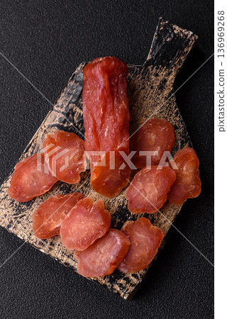 Sliced smoked dry sausage made from turkey or pork for sandwiches. Sliced smoked sausage Sliced smoked dry sausage made from turkey or pork for sandwiches. Sliced smoked sausage 136969268