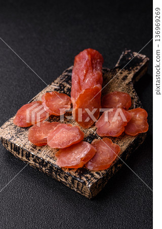 Sliced smoked dry sausage made from turkey or pork for sandwiches. Sliced smoked sausage Sliced smoked dry sausage made from turkey or pork for sandwiches. Sliced smoked sausage 136969269
