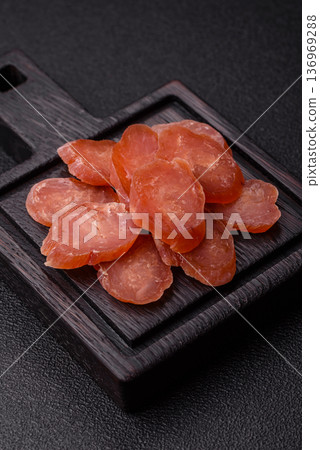 Sliced smoked dry sausage made from turkey or pork for sandwiches. Sliced smoked sausage 136969288