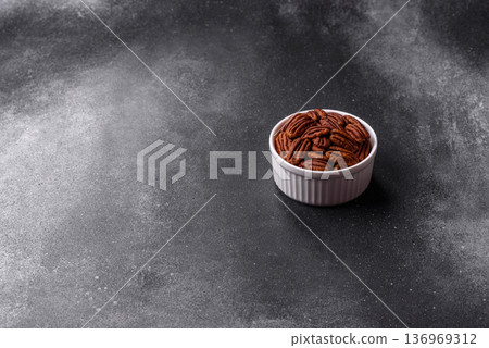 Peeled and roasted pecan nut as an ingredient for healthy food. Pecan nut as a food background 136969312