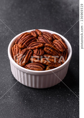 Peeled and roasted pecan nut as an ingredient for healthy food. Pecan nut as a food background Peeled and roasted pecan nut as an ingredient for healthy food. Pecan nut as a food background 136969319