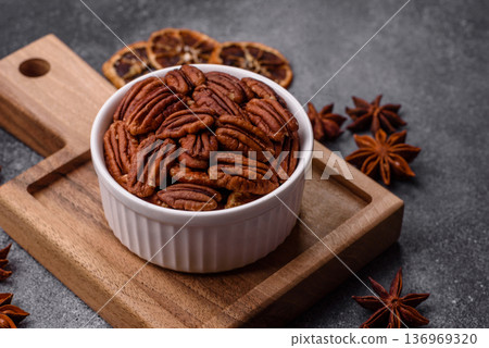 Peeled and roasted pecan nut as an ingredient for healthy food. Pecan nut as a food background Peeled and roasted pecan nut as an ingredient for healthy food. Pecan nut as a food background 136969320