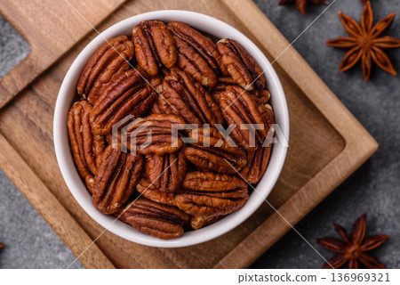 Peeled and roasted pecan nut as an ingredient for healthy food. Pecan nut as a food background 136969321