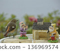 A robin gets lost in the land of the dwarfs. 136969574