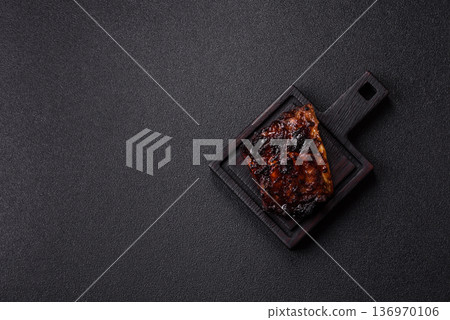 Grilled or barbecued pork or beef ribs, meat with red sauce for the dinner table. Grilled ribs 136970106