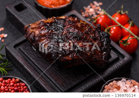 Grilled or barbecued pork or beef ribs, meat with red sauce for the dinner table. Grilled ribs Grilled or barbecued pork or beef ribs, meat with red sauce for the dinner table. Grilled ribs 136970114