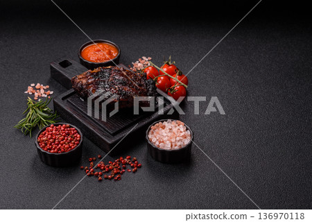 Grilled or barbecued pork or beef ribs, meat with red sauce for the dinner table. Grilled ribs Grilled or barbecued pork or beef ribs, meat with red sauce for the dinner table. Grilled ribs 136970118