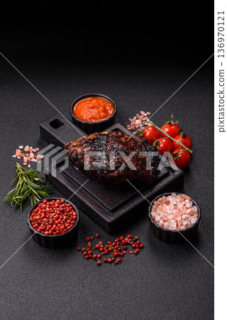 Grilled or barbecued pork or beef ribs, meat with red sauce for the dinner table. Grilled ribs 136970121