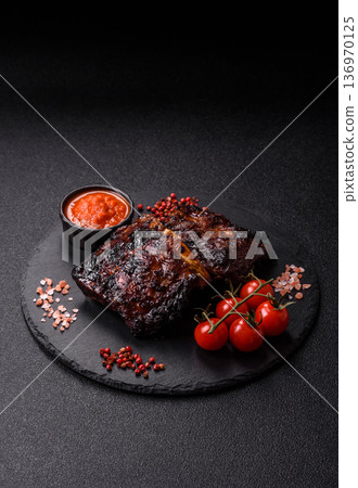 Grilled or barbecued pork or beef ribs, meat with red sauce for the dinner table. Grilled ribs 136970125