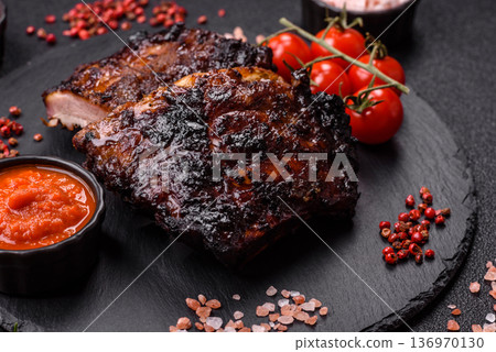 Grilled or barbecued pork or beef ribs, meat with red sauce for the dinner table. Grilled ribs Grilled or barbecued pork or beef ribs, meat with red sauce for the dinner table. Grilled ribs 136970130