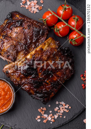Grilled or barbecued pork or beef ribs, meat with red sauce for the dinner table. Grilled ribs 136970132
