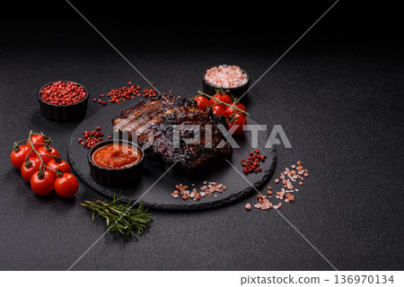 Grilled or barbecued pork or beef ribs, meat with red sauce for the dinner table. Grilled ribs 136970134